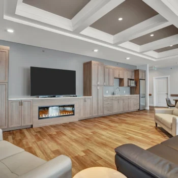 St. Brieux Manor activity room with tv and fireplace